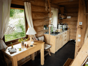 Kitchen area of a charming cabin in East Tennessee, featuring natural wood cabinetry and a rustic design for a mountain home.