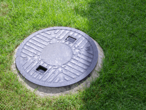 Septic tank access lid installed in a residential yard for septic system inspection in Gatlinburg Tennessee