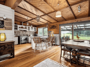 Interior kitchen and dining area of a Smoky Mountain cabin in Gatlinburg Tennessee with wood ceilings and open layout